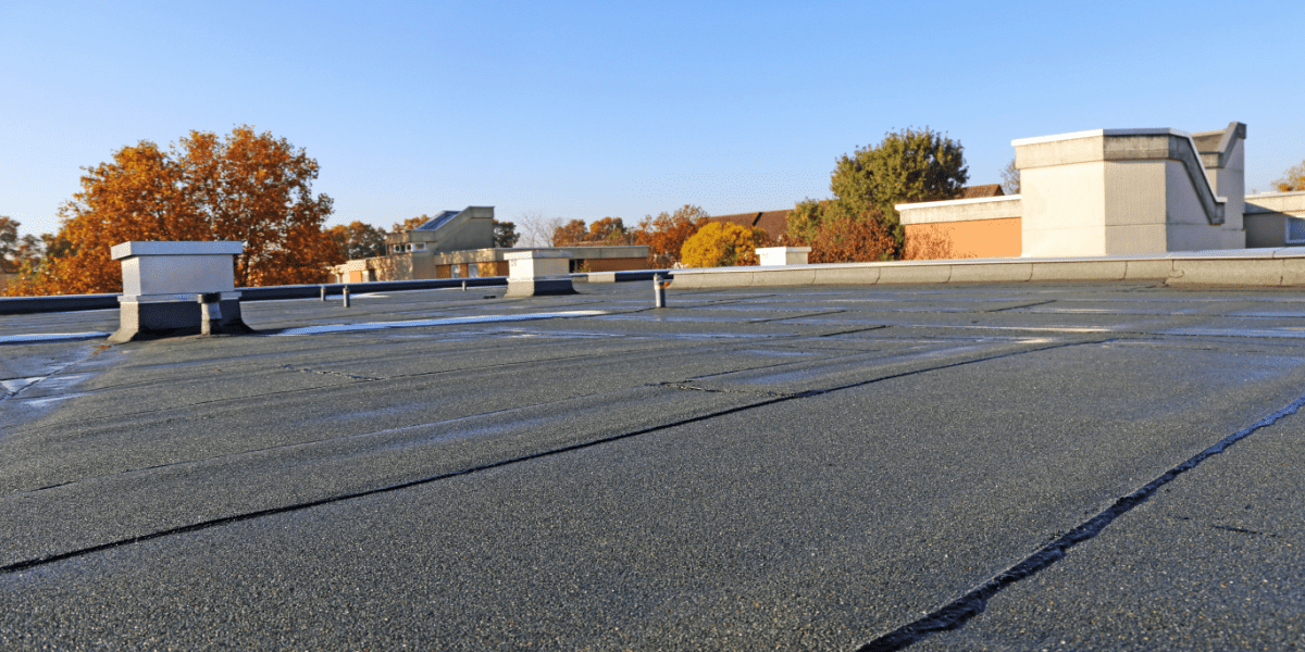 Building with newly renovated flat roof sealing